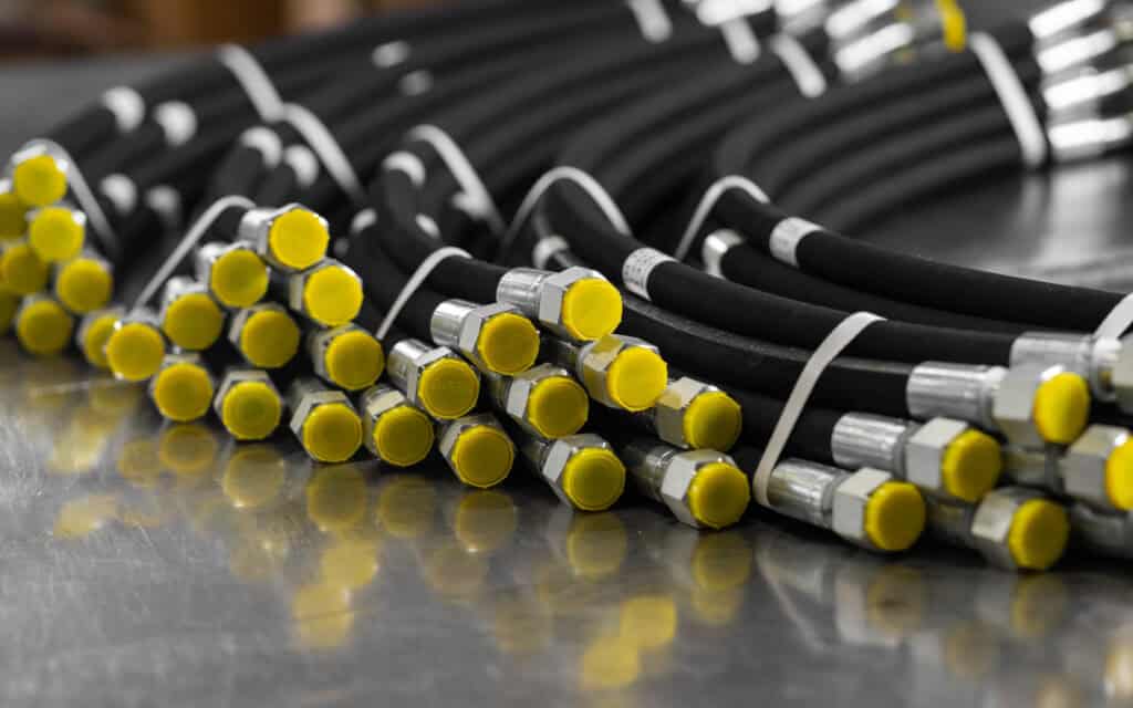A,bundle,of,new,high Pressure,hydraulic,hoses,are,lying,on